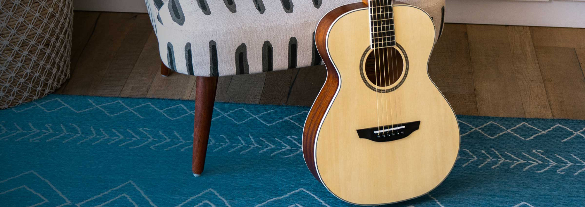 Dana spruce guitar on a blue rug