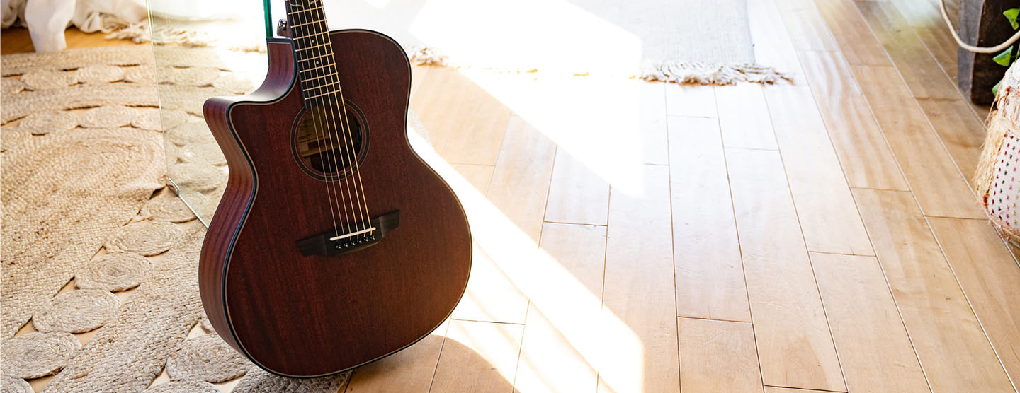 Morgan Mahogany Live guitar on a wooden floor